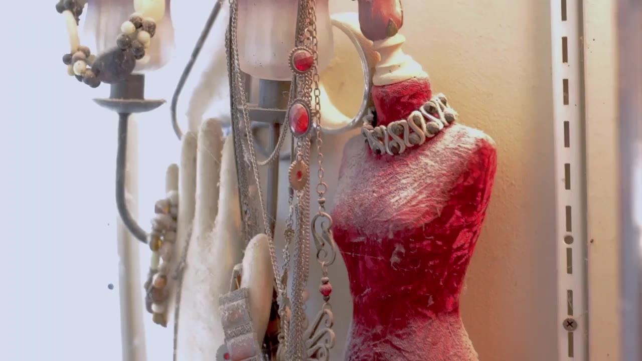Elegant jewelry display on red mannequin bust