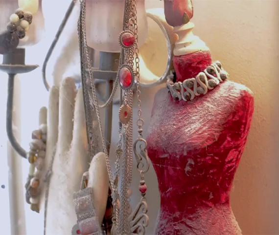 Elegant jewelry display on red mannequin bust